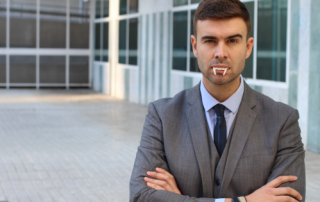 Image of a man in a suit with vampire teeth