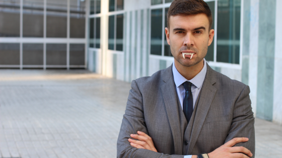 Image of a man in a suit with vampire teeth