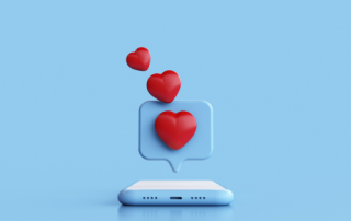 Social Media Marketing: blue phone with red like hearts coming out of the phone