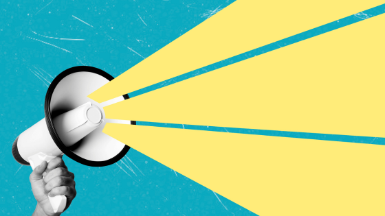 a white megaphone being held by a hand with an illustrated yellow beam coming out of it